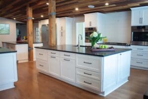 Brentwood kitchen renovation in log home with white cabinets, black countertops